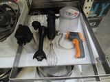 an image of a kitchen drawer with utensils and a mixer