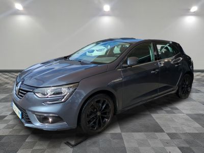 a grey car parked in a garage with a checkered floor
