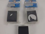 four pieces of plastic on a white surface with a cell phone