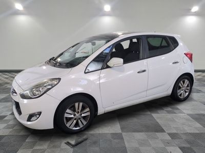 a picture of a white car parked in a showroom