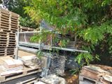 a large pile of wooden pallets in a yard