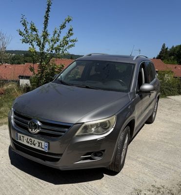 a silver car parked on a dirt road in the country