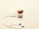 a gold ring with a white cord and a tag on it