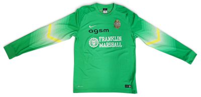 a close up of a green shirt with a soccer ball on it