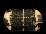an old stone with writing on it on a black background