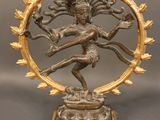 a bronze statue of a man on a circular base