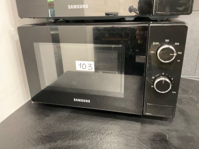 two microwaves on top of each other on a counter