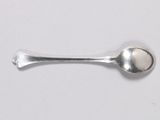 a spoon and a spoon rest on a white surface