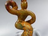 statue of a woman holding a baby in her arms on a clear base
