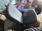 a person sitting on a motor scooter in the street