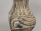 an old vase with a decorative design on it