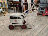 a small crane that is sitting on a wooden floor