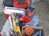 a pile of tools and tools in a box on the ground