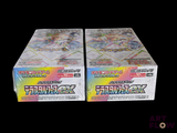 two boxes of pokemon trading cards on a black background