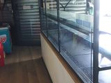 a glass display case in the middle of a long hallway