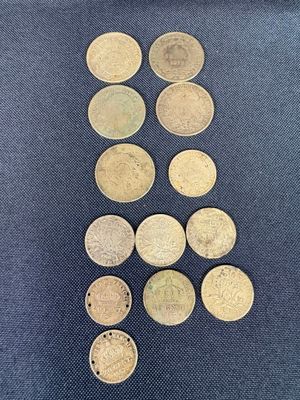 a pile of coins sitting on top of a blue cloth