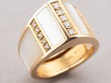 a close up of a gold ring with white and clear stones