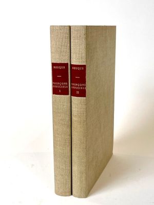 two books sitting on top of each other on a white surface
