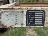 a rusted metal sign on the back of a truck