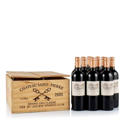 six bottles of wine in a wooden box on a white surface