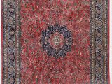 a red and blue rug with a medallion design on the center