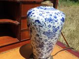 a blue and white vase sitting on a wooden table