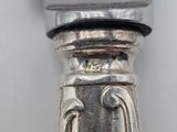 a close up of a silver spoon on a table