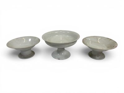 three bowls sitting on pedestals on a white surface