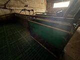 a green machine that is in a room with a window