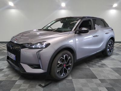 the front view of a silver suv parked on a checkered floor