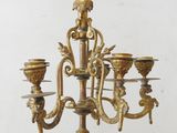 a gold colored candelab with five candles on it
