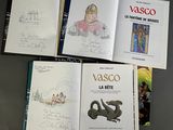 three books with drawings of people and animals on them sitting on a table