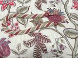 a close up of a bed with a floral design on it