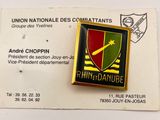 badge of a military unit with a red, green, and yellow shield on it