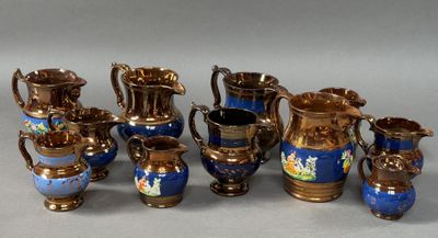 many different types of blue and gold vases on the table