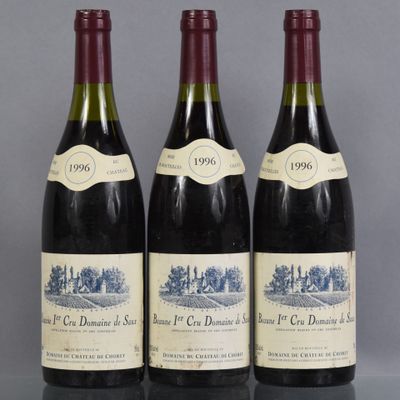 three bottles of wine are lined up on a table