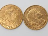 two gold sovereigns, one of which is a woman and one of which is a man