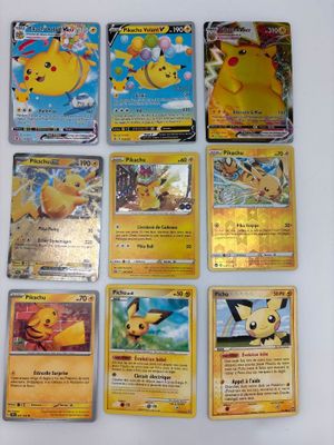 Plusieurs cartes Pokémon sont posées sur une table avec un fond blanc.