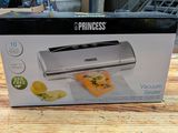 the box is open on a table with a sandwich and lemon slicer in it