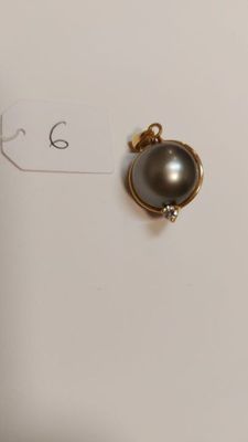 a close up of a small black pearl on a white surface