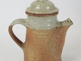 a coffee pot with a lid on a white surface