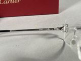 a pair of glasses sitting on a table next to a cartier box
