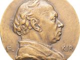 a close up of a coin with a man ' s face on it