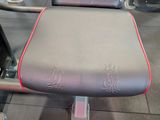 a black and red bench in a gym room