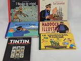 four children ' s books are lined up on a white surface