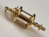 an image of a gold plated object on a white surface