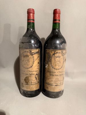 two bottles of wine sitting next to each other on a table
