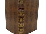an old brown book with gold trimmings on it