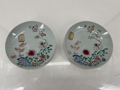 pair of blue and white plates with flowers and birds on them