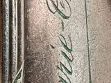 a close up of a silver spoon with writing on it